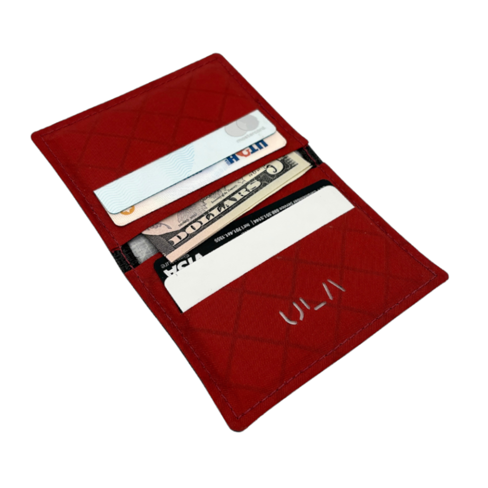 A Chili Red Wasatch Wallet lies open